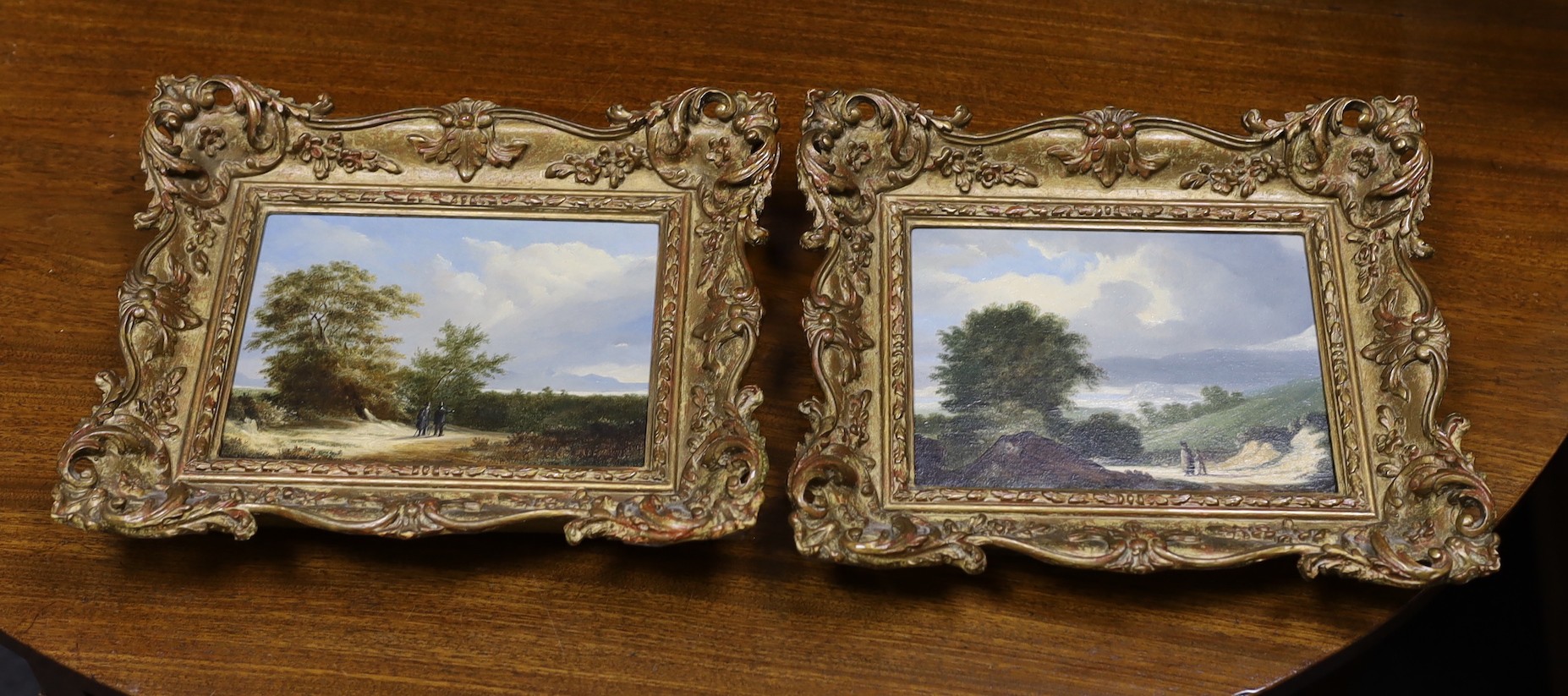 Manner of James Arthur O’Connor (Irish, 1792-1841), Travellers in landscapes, Oil on wooden panel, a pair, 14 x 19cm